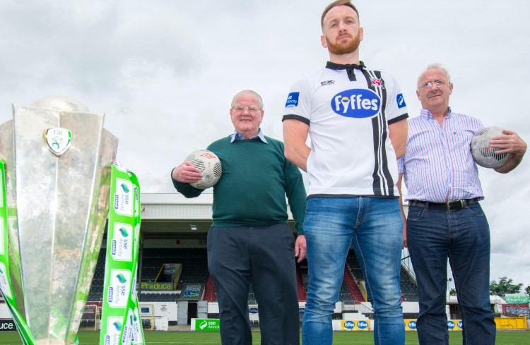 NEW DUNDALK FC VIDEO COMPLETES ‘TRILOGY’Dundalk Football Club continues to expand its global appeal thanks to a series of YouTube videos produced on the club's behalf by team sponsors Fyffes – the third of which has just been released.Appropriately entitled ‘the Captain’s Armband’ – it tells the story of Dundalk FC as seen through the eyes of club captains, past and present and follows the success of the first two productions which attracted 70,000 and 180,000 views respectively within weeks of being released. Its stars - current club captain Stephen O’Donnell and previous captains John Murphy (1962/63) (left) and Dermot Keely (1979/81) were on hand at Oriel Park to welcome the new production.